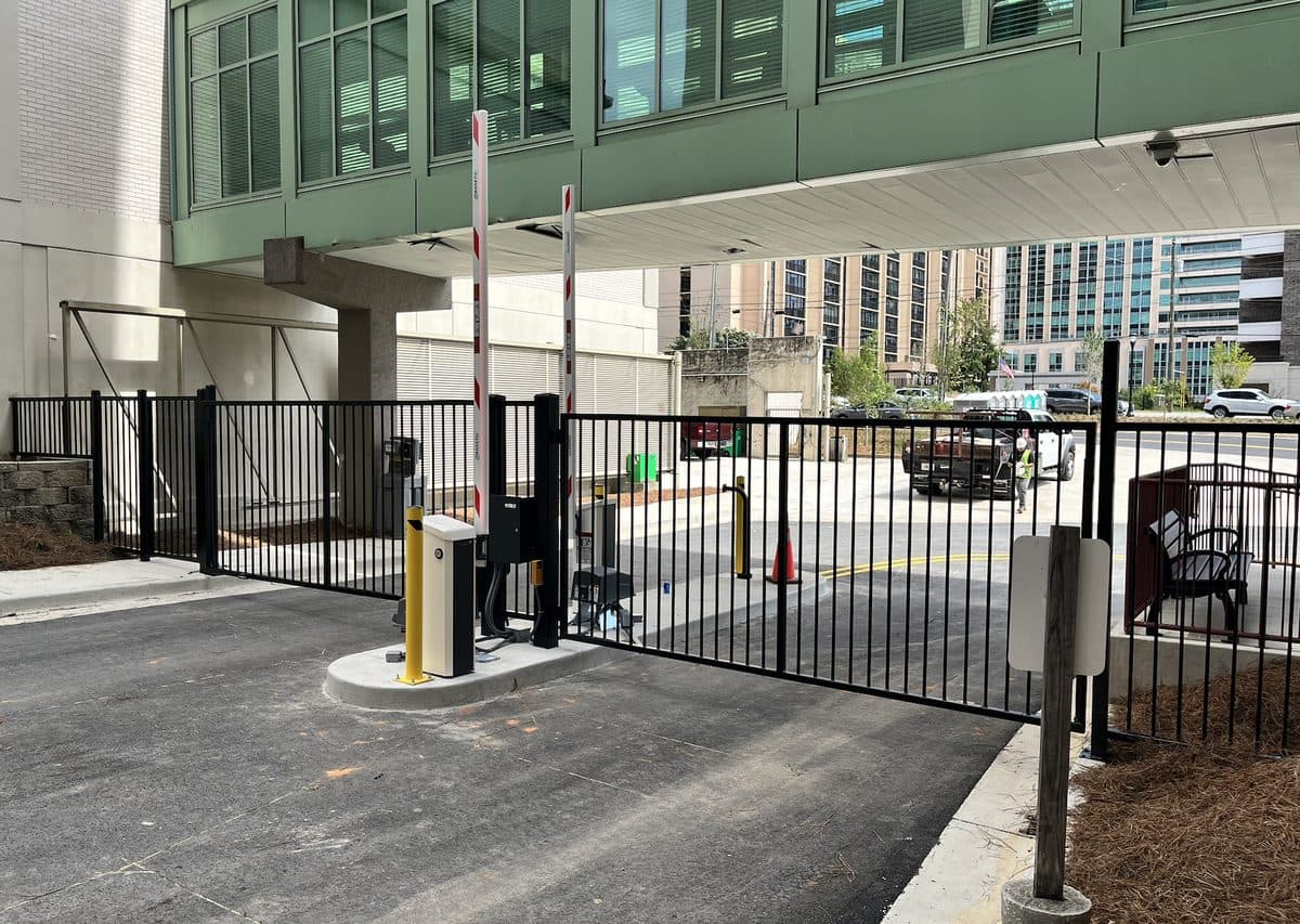 Black aluminum fence and gate with parking bollards in Georgia