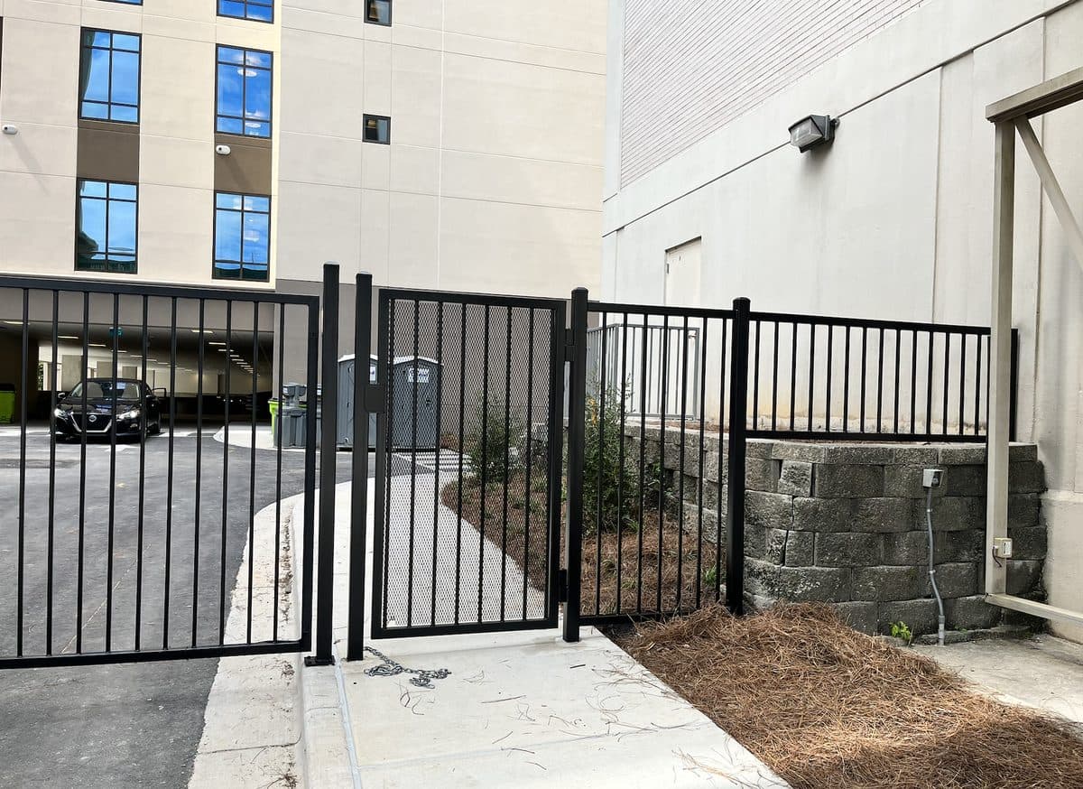 Black aluminum fence with swing gate at hotel in Georgia
