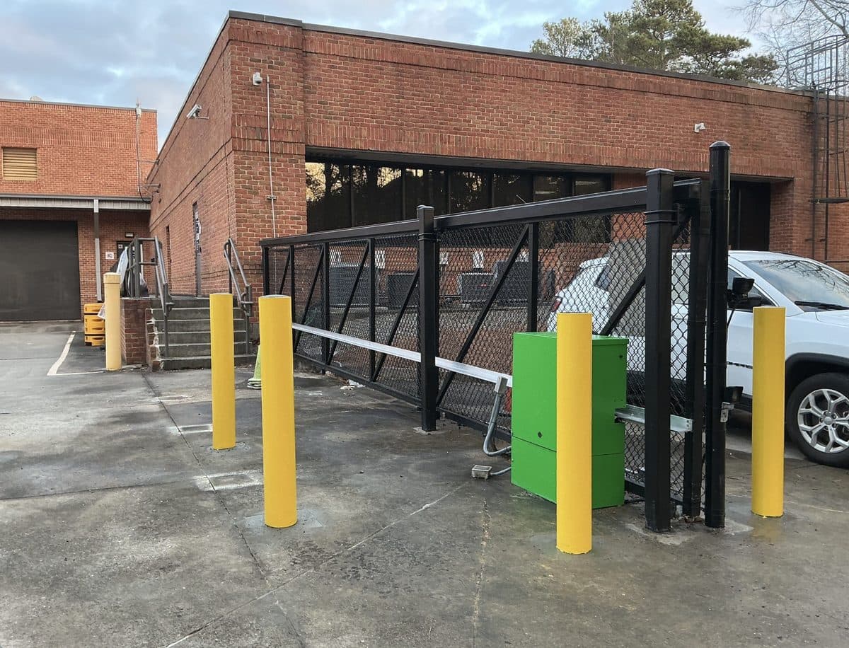 Black chain link cantilever gate with bollards in Atlanta, GA