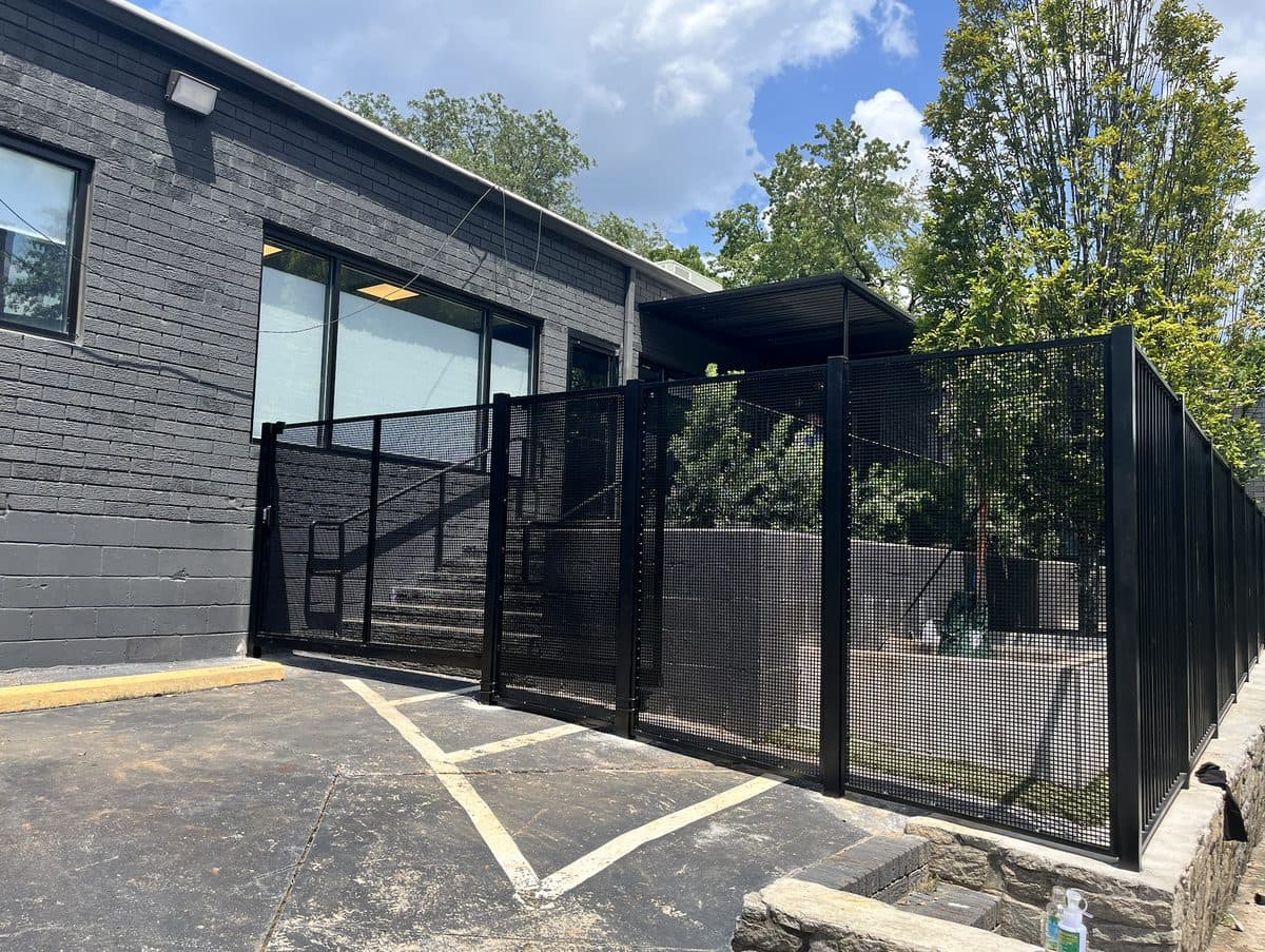 Black mesh panel fence wrapping commercial building in Georgia