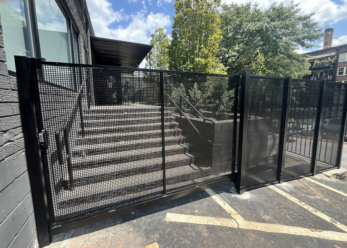 Black mesh panel fence with walk gate at commercial building in Georgia