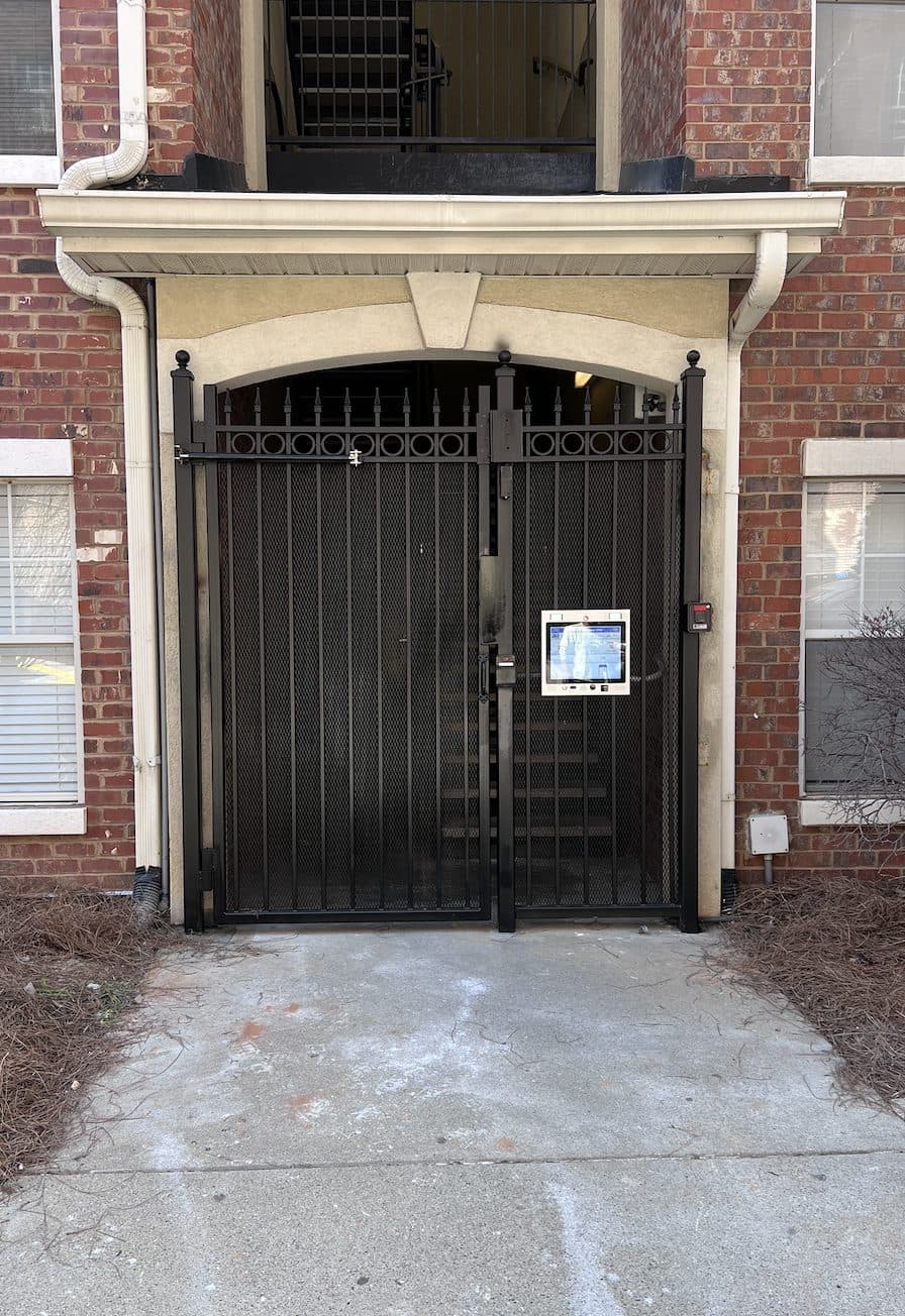 Black ornamental gate with ring pattern and access control in Georgia