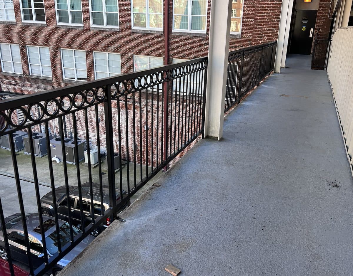 Black ornamental railing with ring pattern along commercial corridor in Georgia
