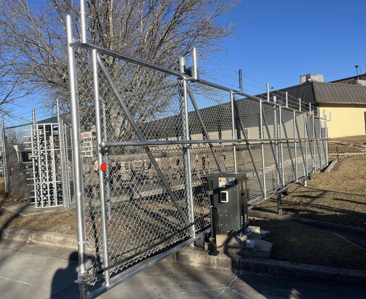 Chain link slide gate with gate operator and barbed wire in Georgia