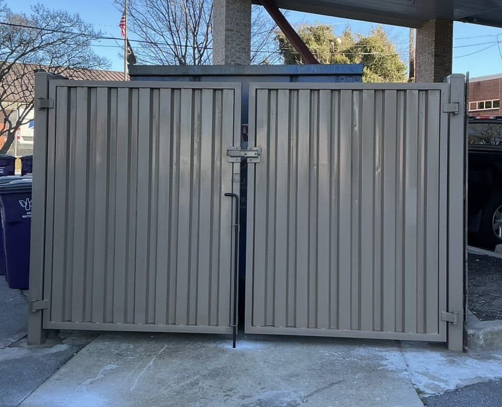 Commercial dumpster gate installed under canopy in Atlanta, GA