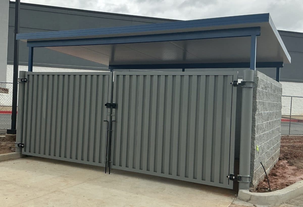 Commercial trash enclosure with metal canopy roof in Georgia