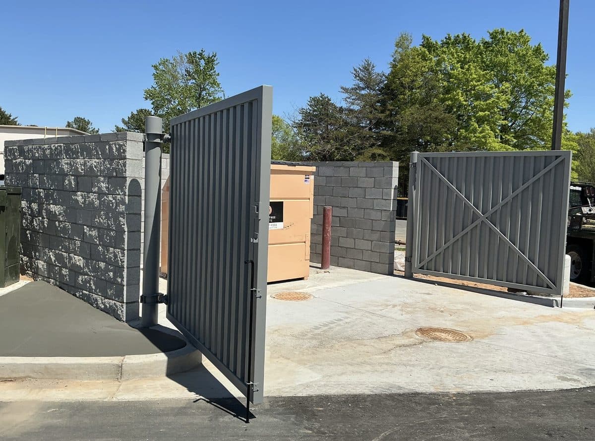 Dumpster enclosure gates installed in block wall in Georgia, gate open