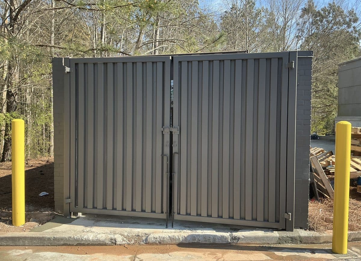 Commercial dumpster gate installation with bollards in Atlanta, GA