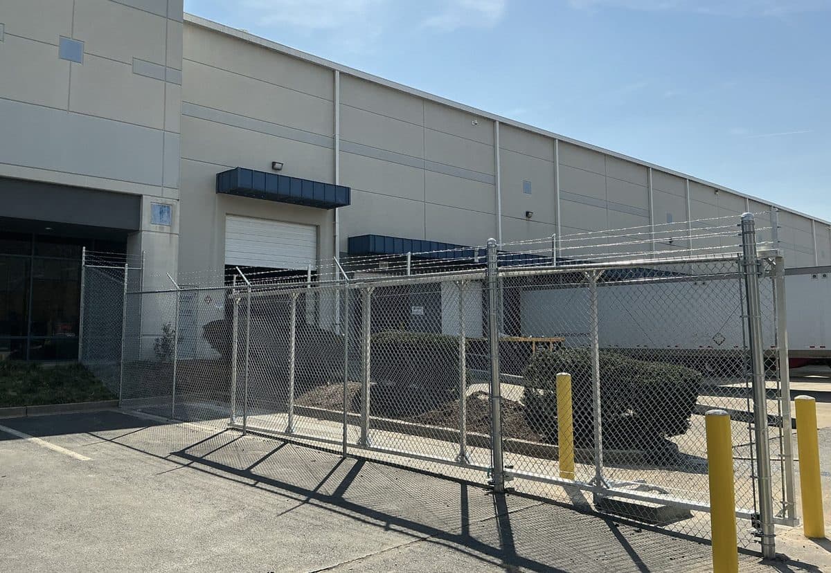 Industrial chain link fence with barbed wire installation in Georgia