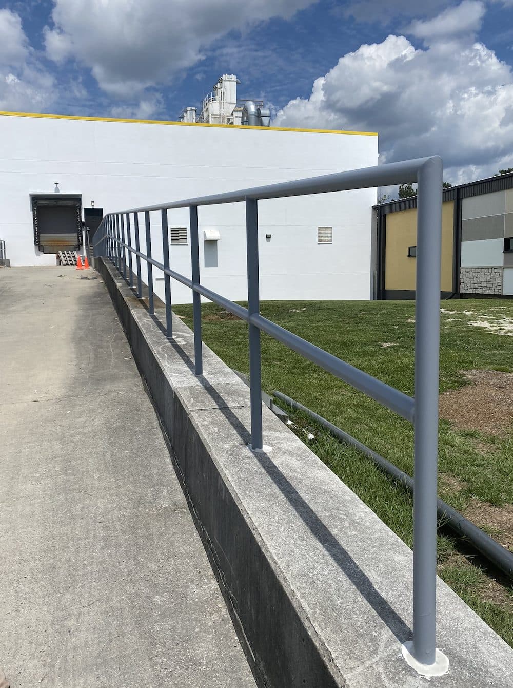 Industrial safety railing along concrete retaining wall in Georgia