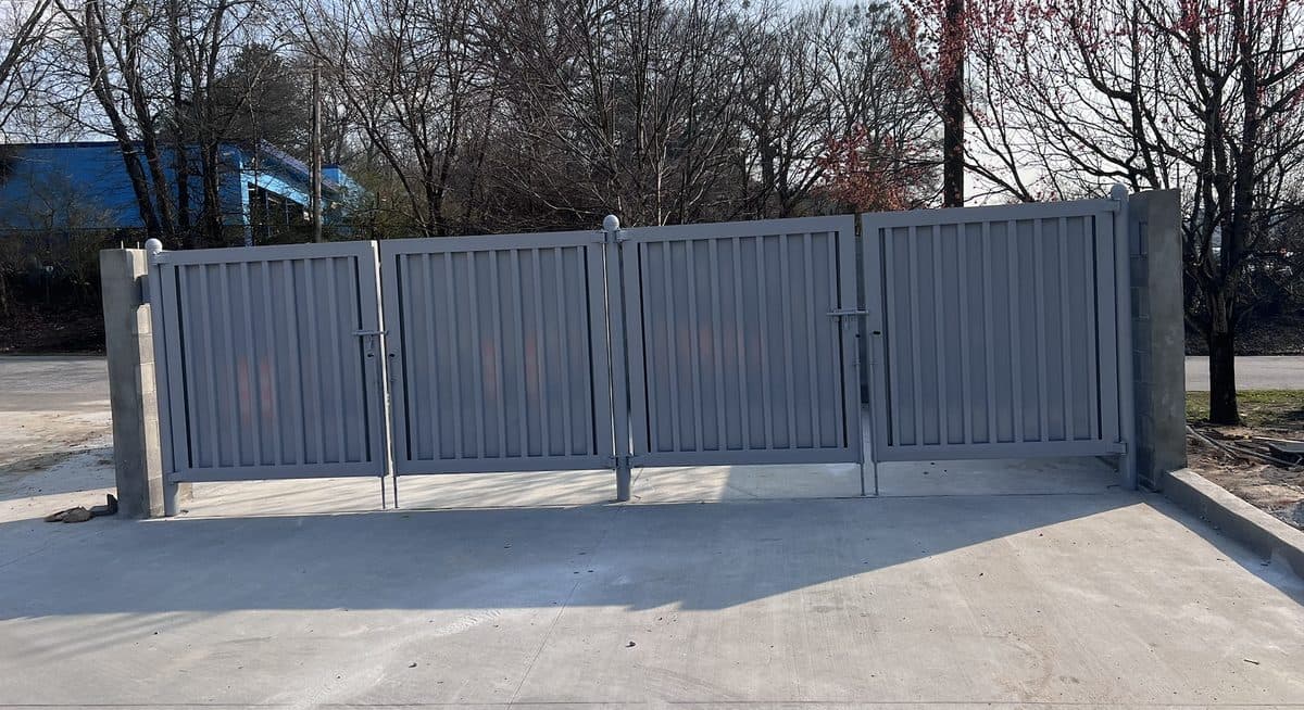 Large multi-panel dumpster enclosure gate installation in Atlanta, GA