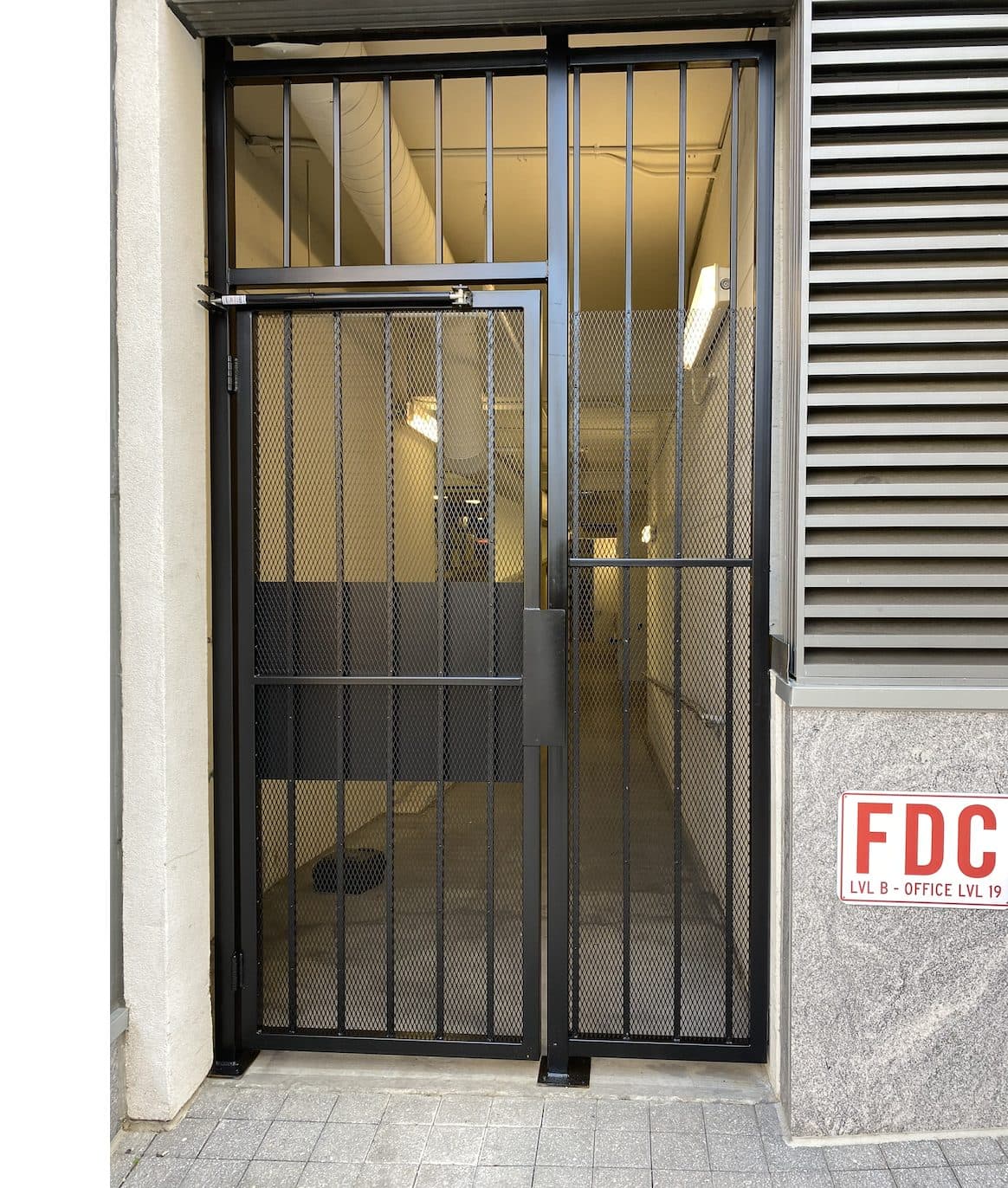 Parking deck mesh gate at building entrance in Georgia
