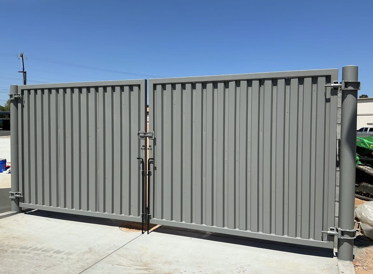 Steel panel dumpster gate with bollard posts in Georgia